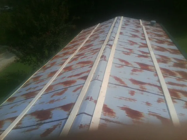 Rusted metal roof panels with new wood purlins before replacement — Storm Damage Roof Repair in Biddeford by Roofing Brothers