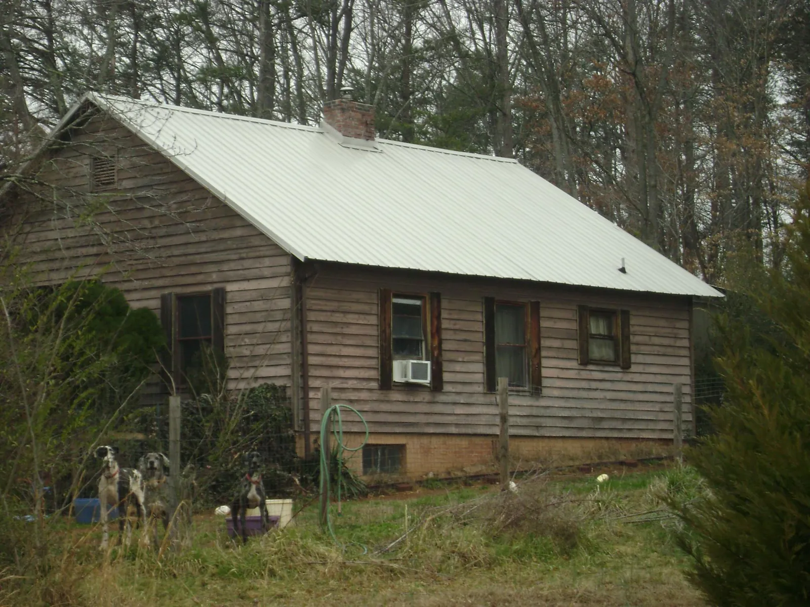 White metal roof on an old wood sided farmhouse, from a Metal Roof Installation job in Biddeford